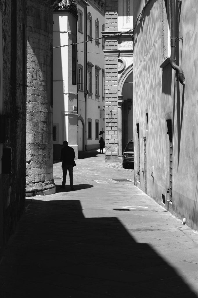 Street photography a Pistoia con forti contrasti di luce e ombra